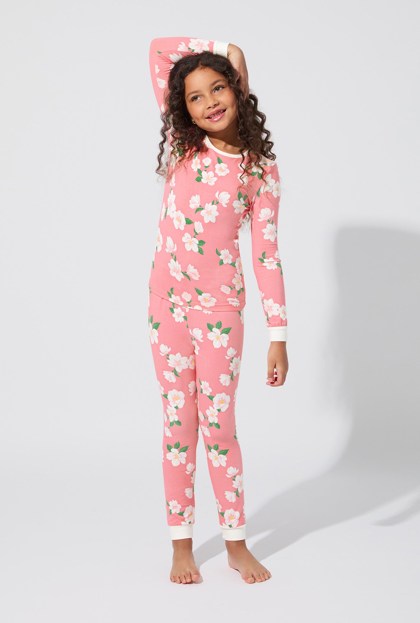 A girl wearing Pink Magnolias Long Sleeve Stretch Jersey Kids PJ Set
