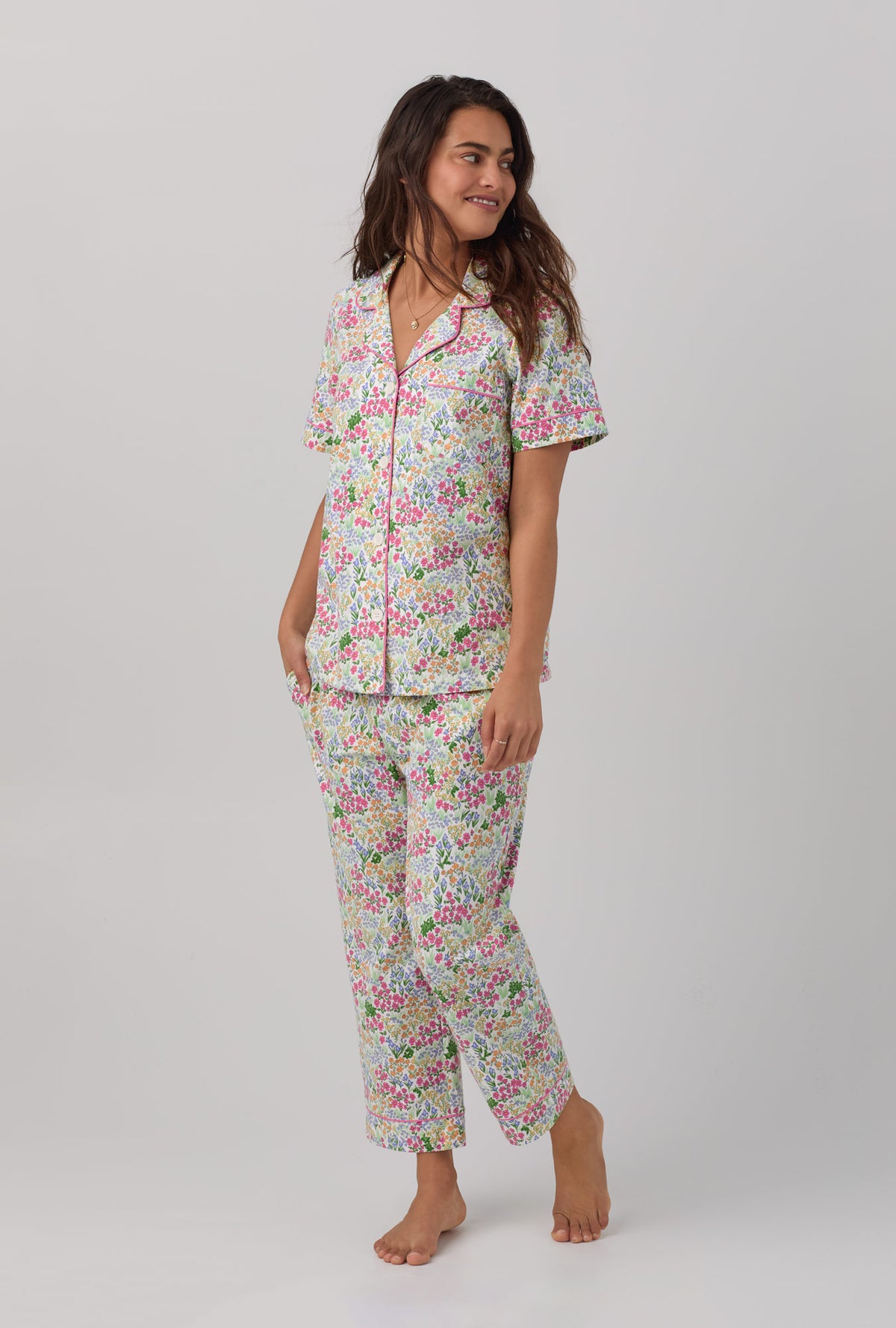 A lady wearing multi color shoe=rt sleeve clasic stretch jersey cropped pj set with cottage garden print.