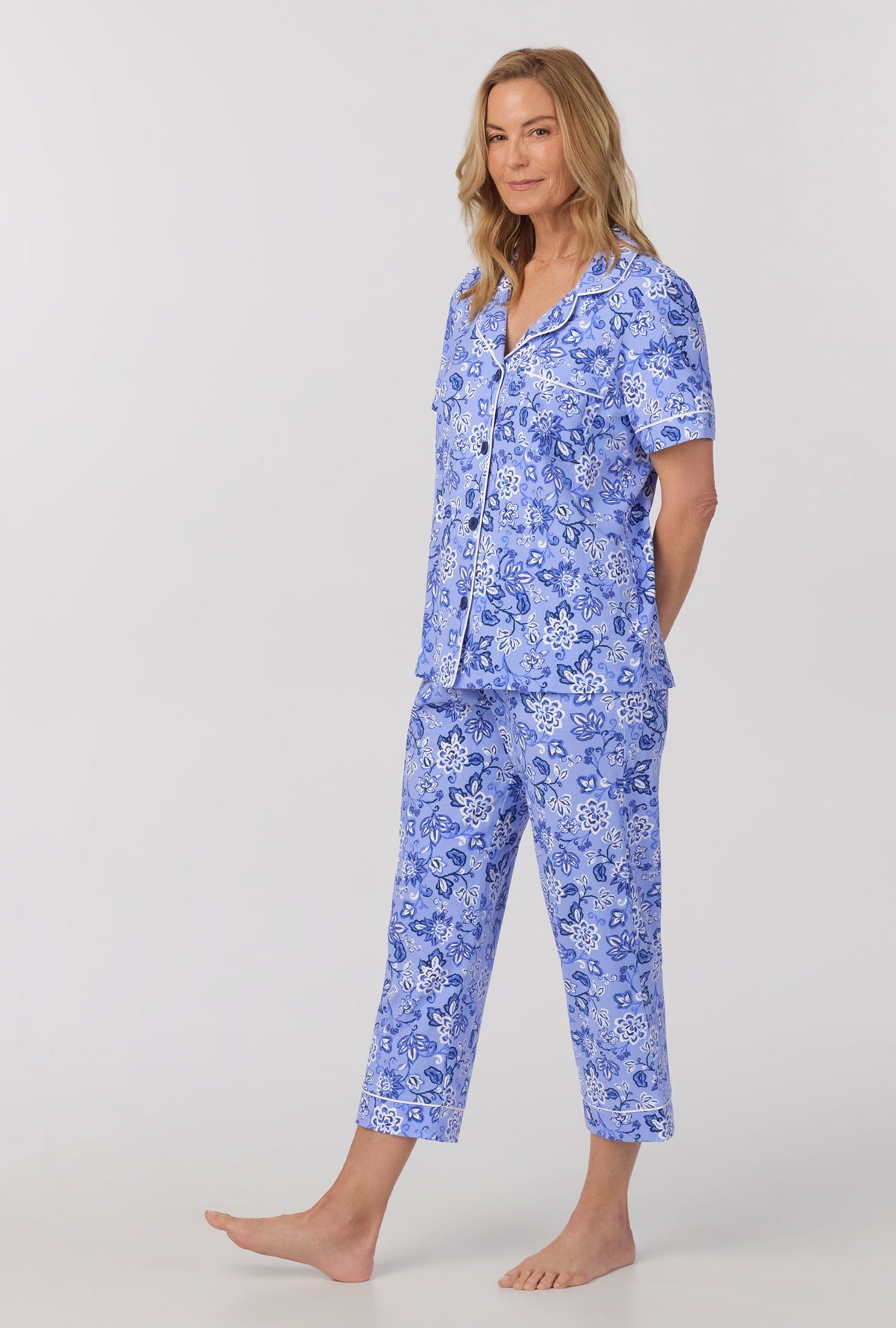 A lady wearing blue short sleeve classic stretch jersey cropped pj set with blue desert flowers print