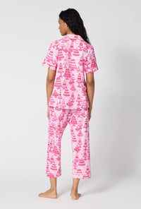 A Lady Wearing Cake Shop Short Sleeve Classic Stretch Jersey Cropped Pj Set Showing a back view pose while looking to the side