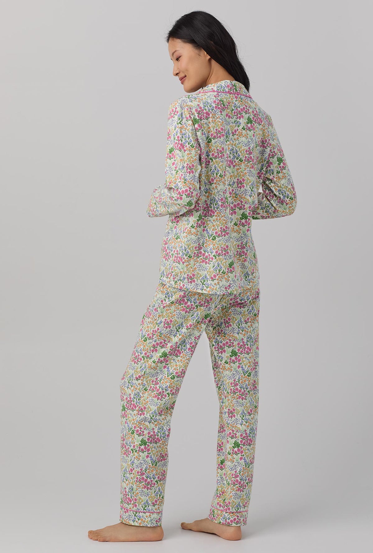 A lady wearing multi color long sleeve classic stretch jersey pj set with cottage garden print.