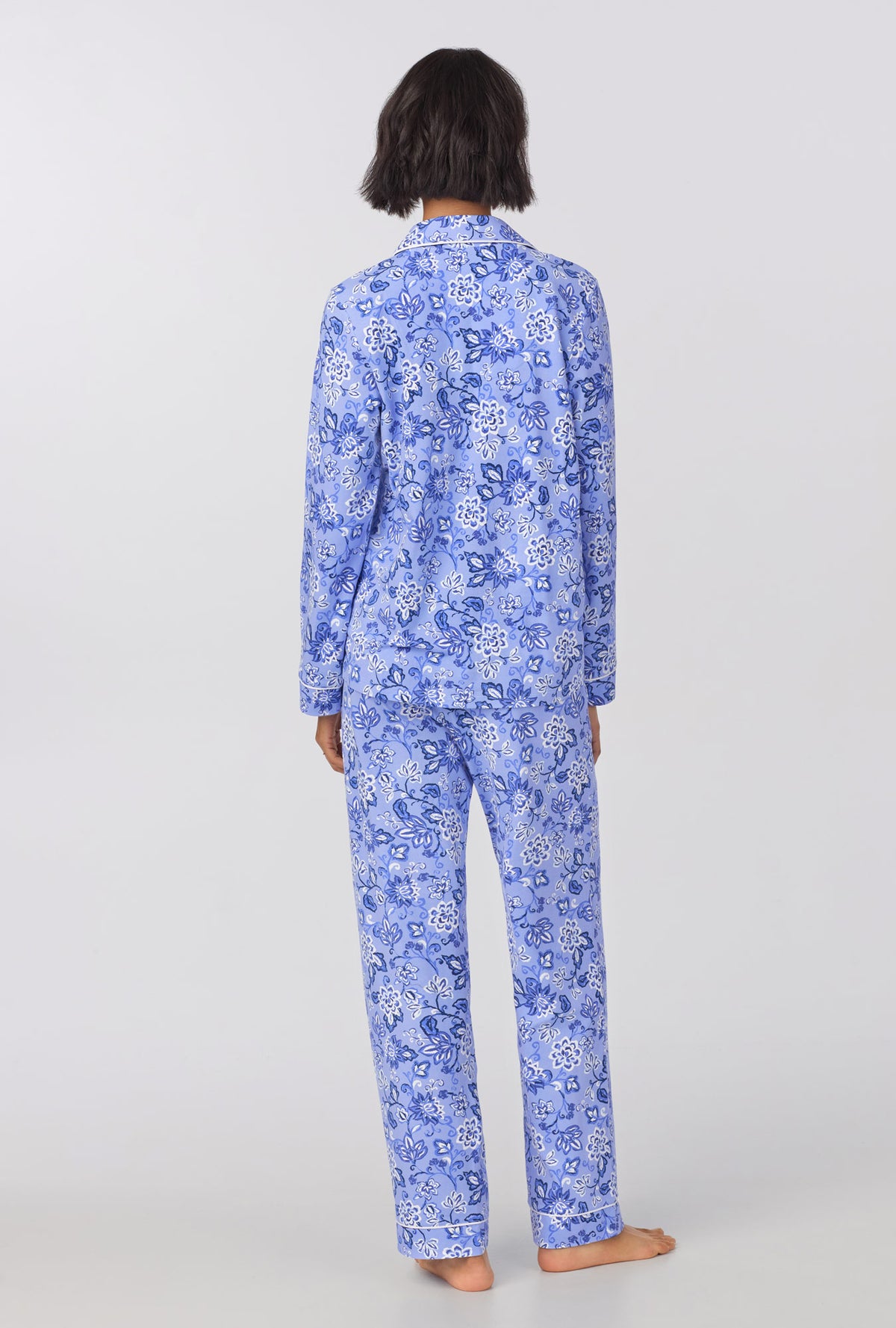 A lady wearing blue long sleeve classic stretch jersey pj set with blue dessert flowers print