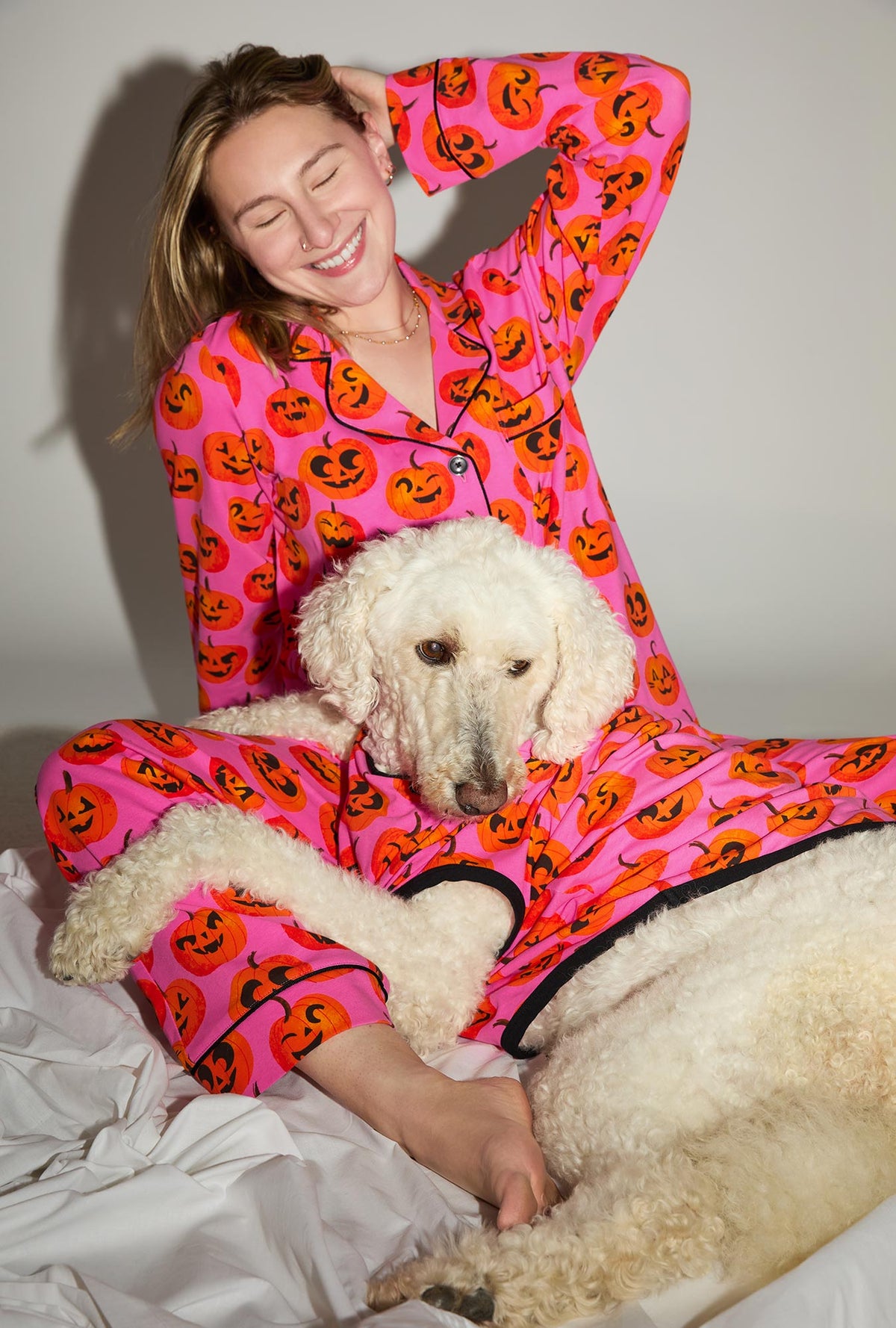 A dog wearing Jolly Jack-O-Lantern Stretch Jersey Dog Pajama