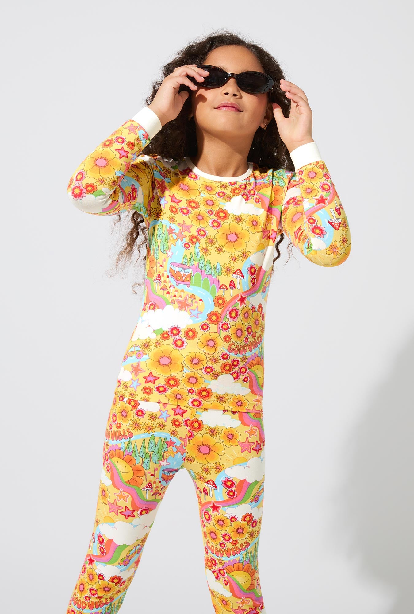 A girl wearing Good Vibes Long Sleeve Stretch Jersey Kids PJ Set