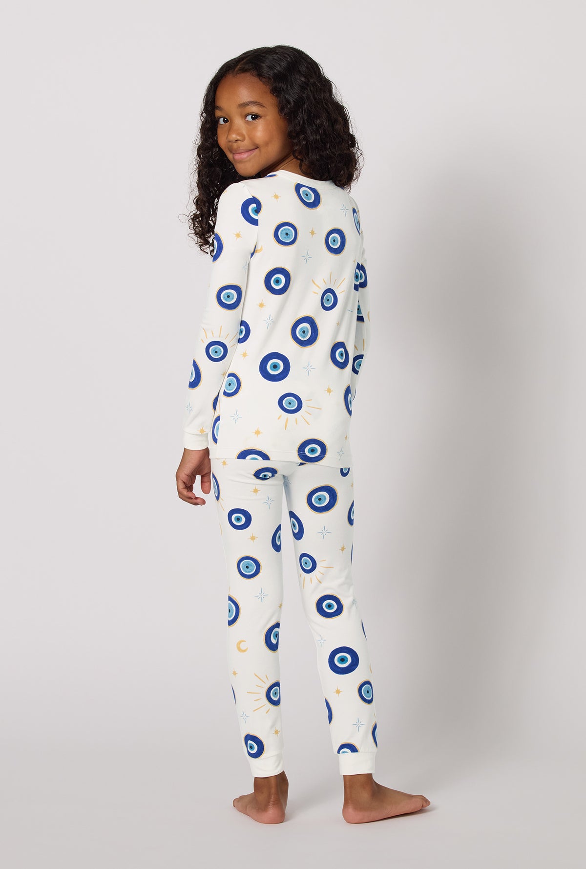 Eyeconic Long Sleeve Stretch Jersey Kids Pj Set in a back view pose while looking back over the shoulder