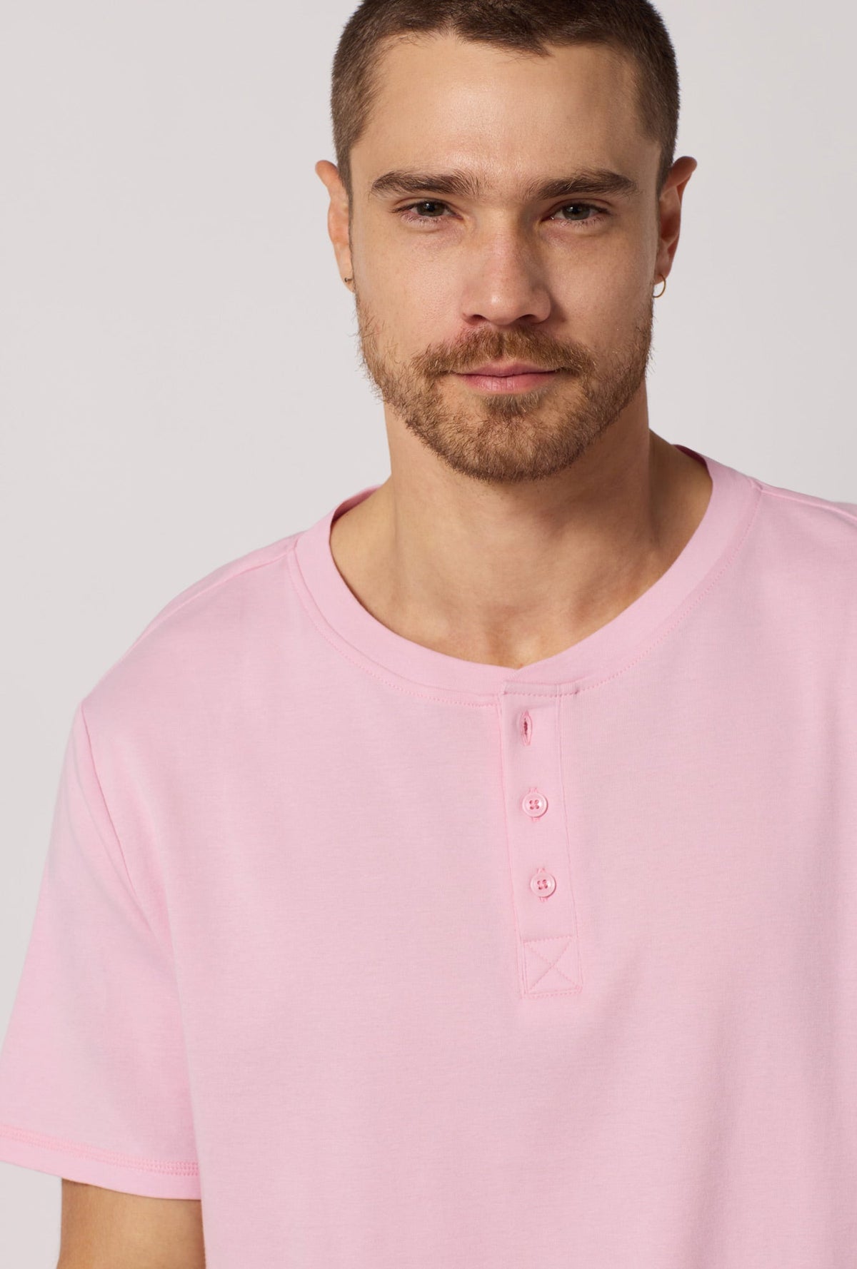 A closeup of A man wearing Green and  Pink Men's Short Sleeve Henley Stretch Jersey Short Pj Set