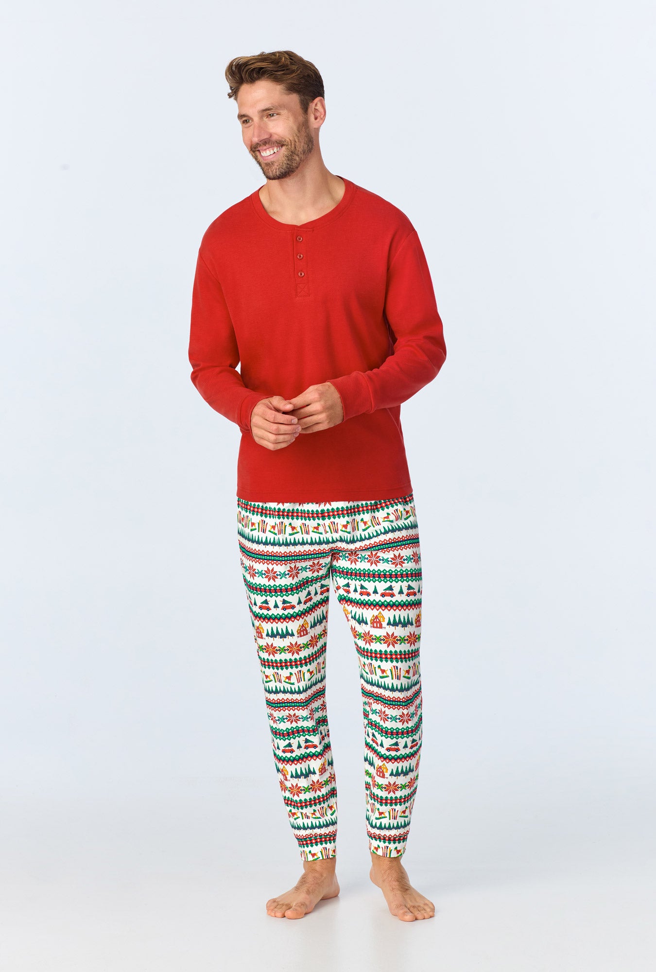 A man wearing Festive Fairisle Men's Long Sleeve Henley and Jogger Stretch Jersey PJ Set