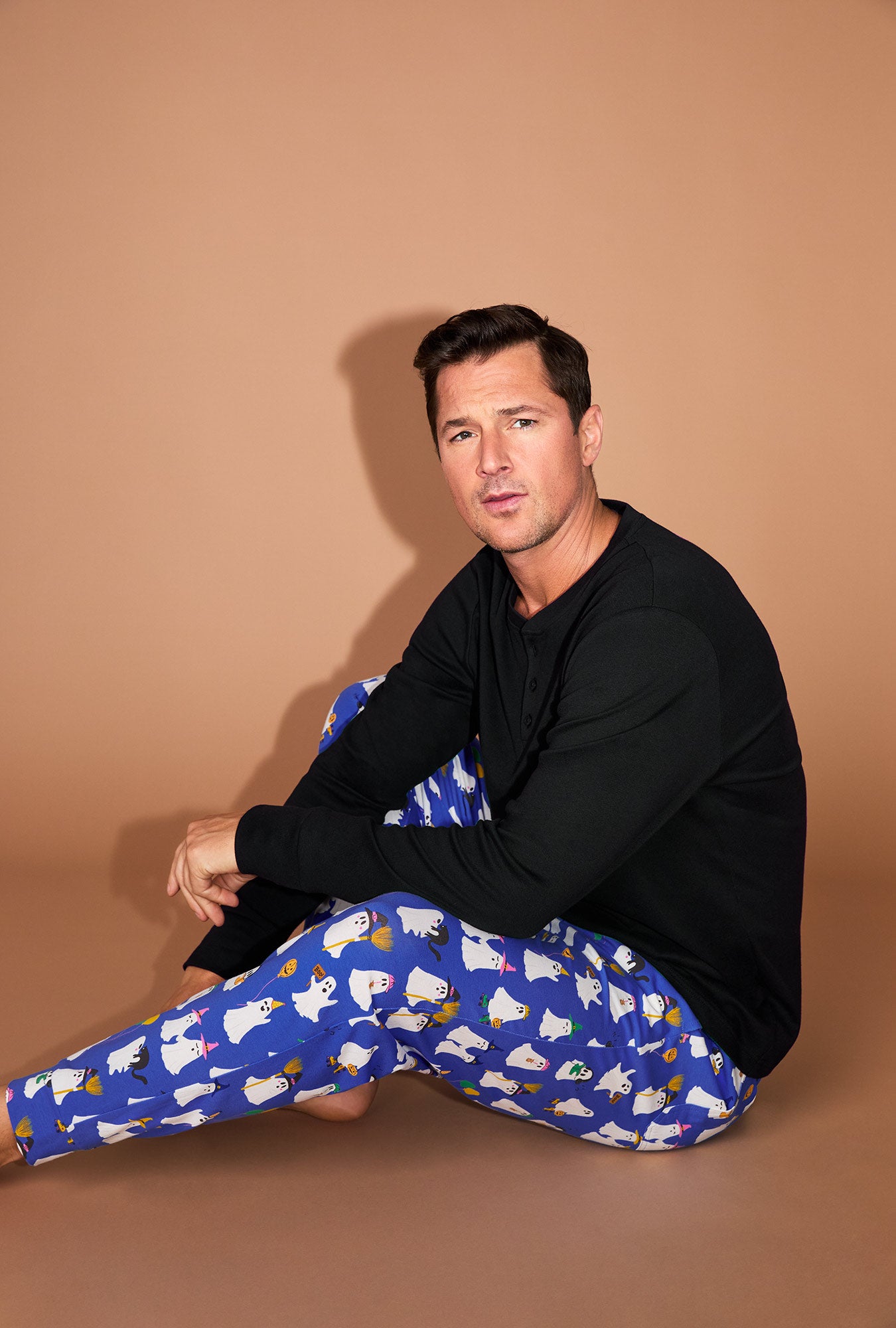 A man wearing That's The Spirit Men's Long Sleeve Henley and Jogger Stretch Jersey PJ Set