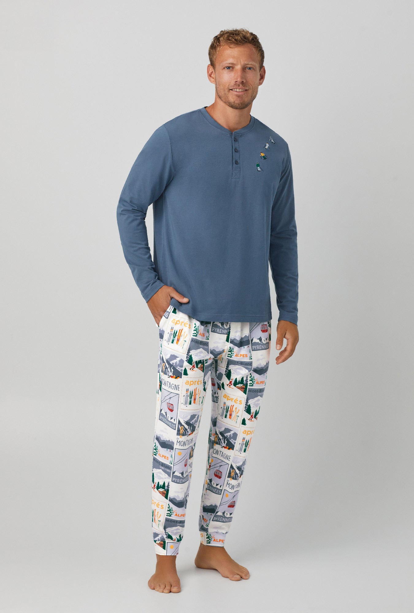A man wearing long sleeve henley and jogger stretch jersey pj set  with holiday getaway.