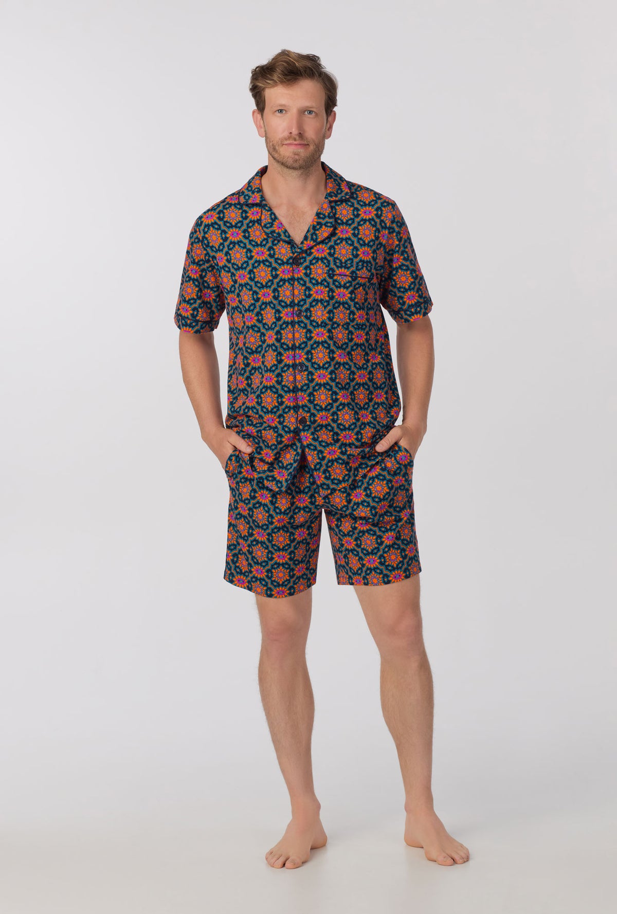 A man wearing short sleeve notch stretch jersey short pj set with navy royal foulard print