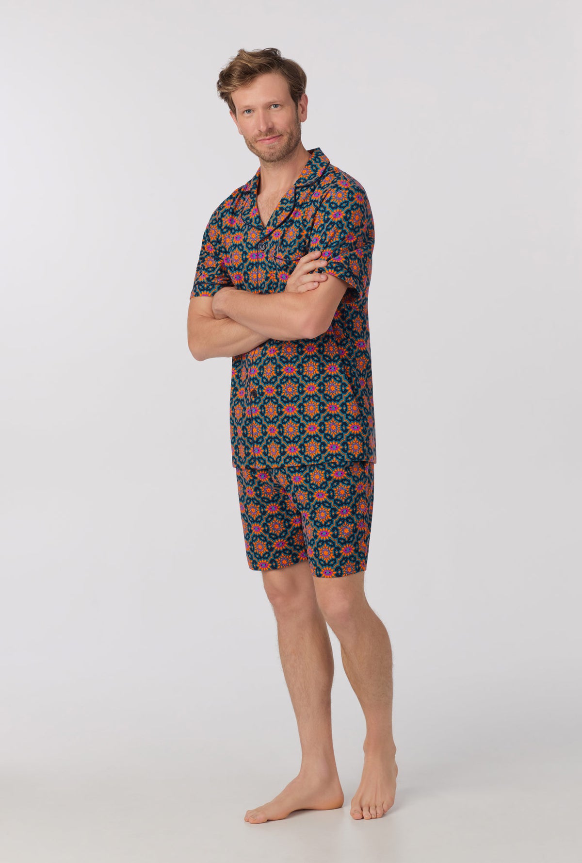 A man wearing short sleeve notch stretch jersey short pj set with navy royal foulard print