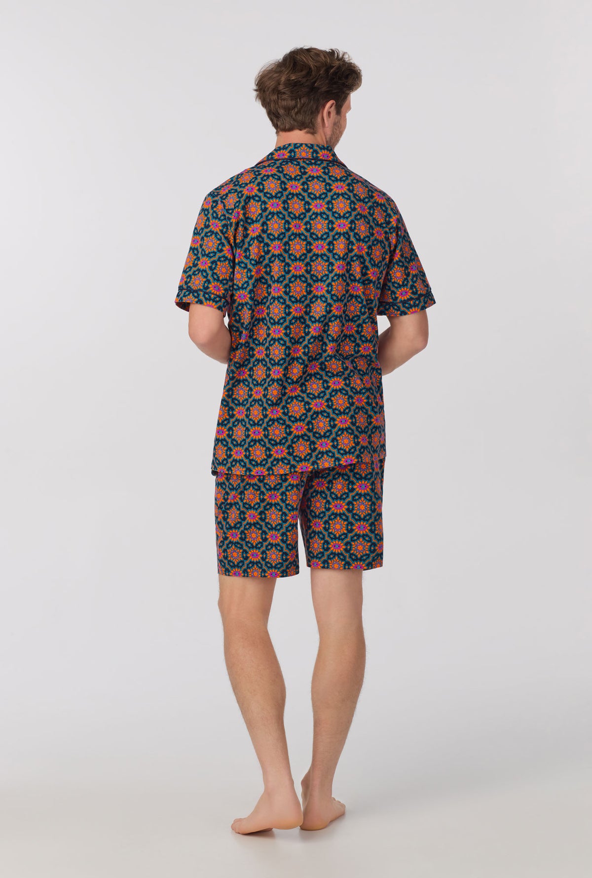 A man wearing short sleeve notch stretch jersey short pj set with navy royal foulard print