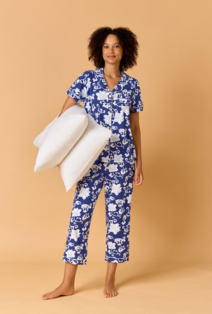 A Lady Wearing Dynasty Blue Short Sleeve Classic Stretch Jersey Cropped Pj Set holding pillows