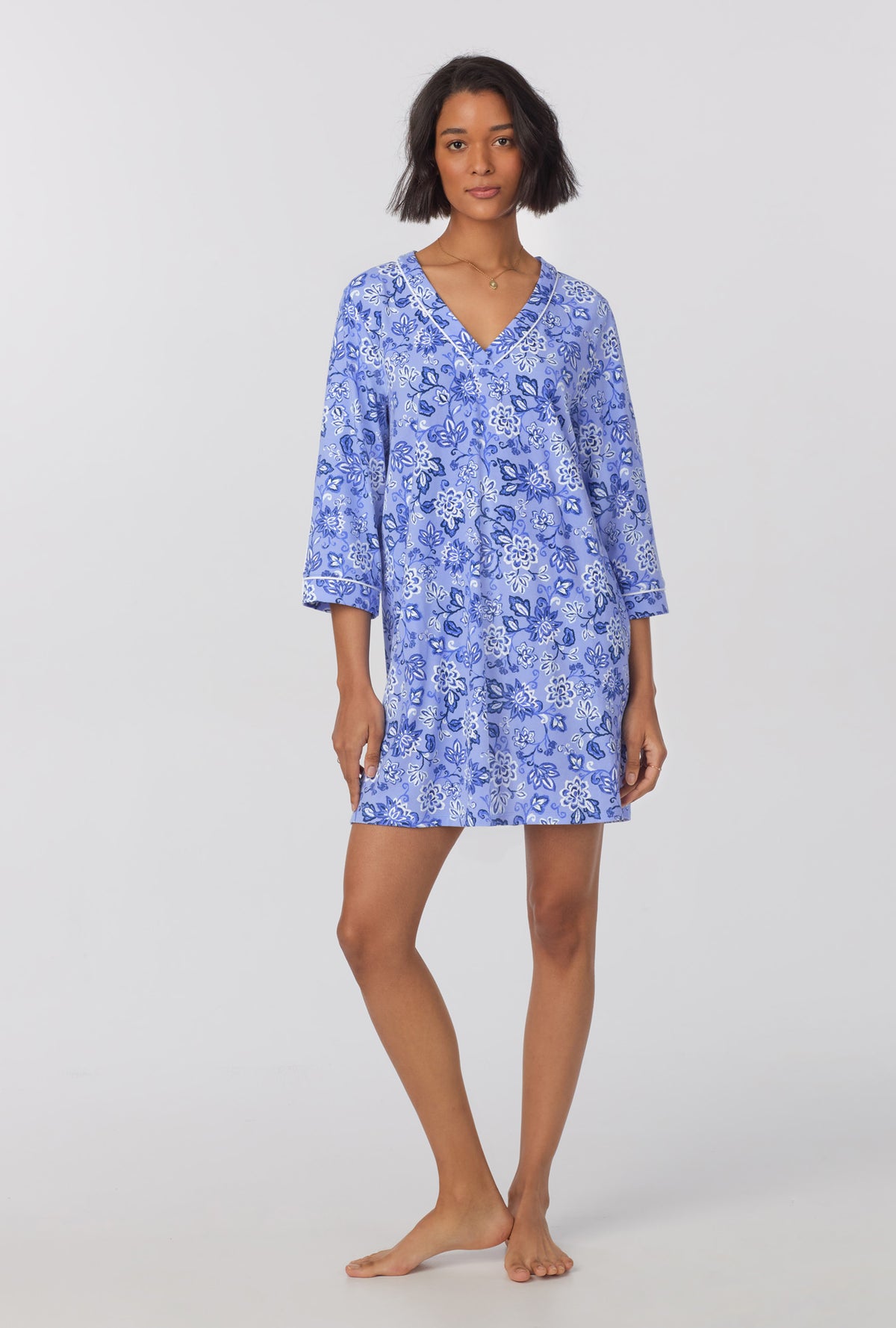 A lady wearing blue 3/4 sleeve stretch jersey sleepshirt with blue dessert flower print