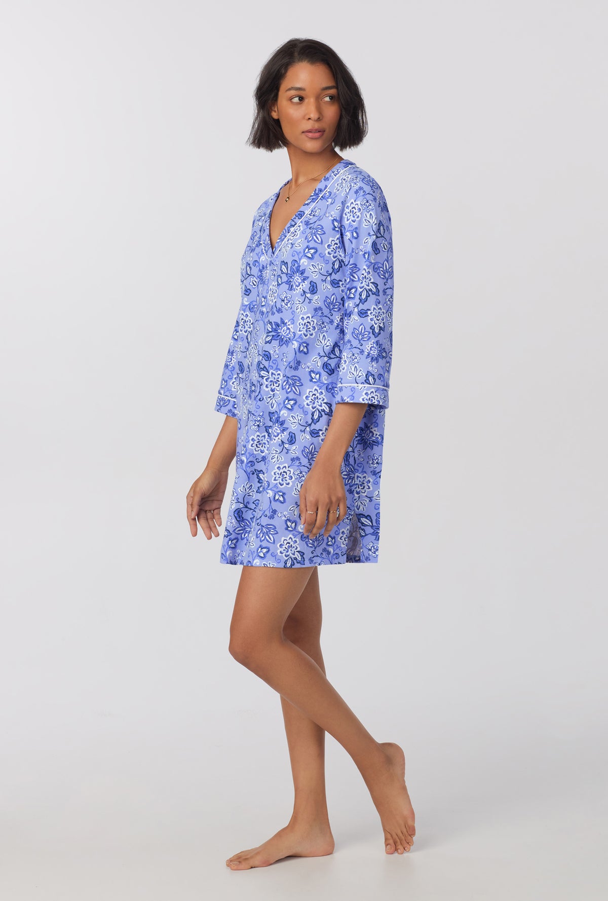 A lady wearing blue 3/4 sleeve stretch jersey sleepshirt with blue dessert flower print