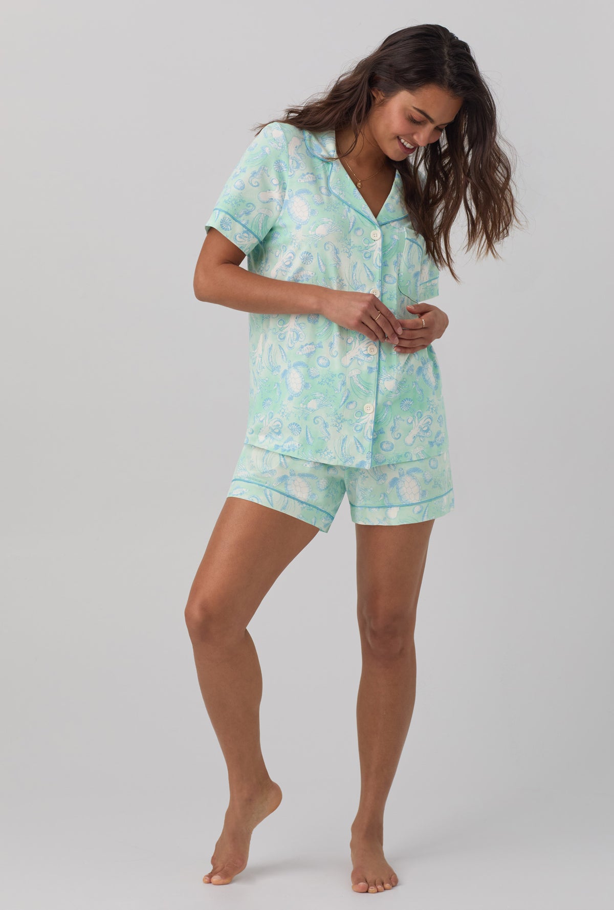 A lady wearing white short sleeve classic shorty stretch jerset pj set with aquatic life print