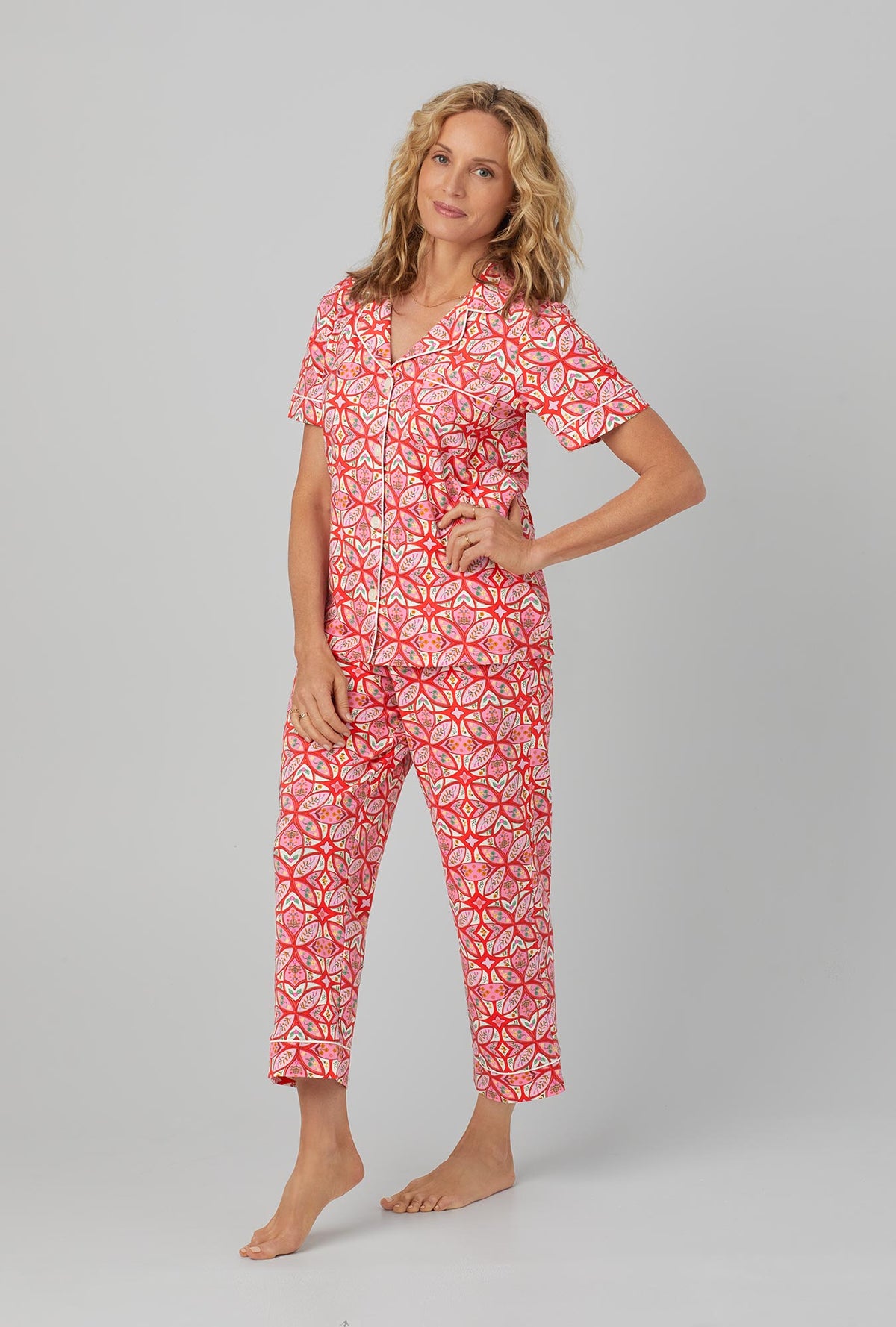 A lady wearing red Short Sleeve Classic Stretch Jersey Cropped PJ Set with Prairie Dawn print