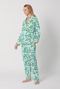 A Lady Wearing Blue Long Sleeve Classic Stretch Jersey PJ Set with Belle Blossoms Print Side Angle View