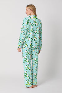A Lady Wearing Blue Long Sleeve Classic Stretch Jersey PJ Set with Belle Blossoms Print Back View