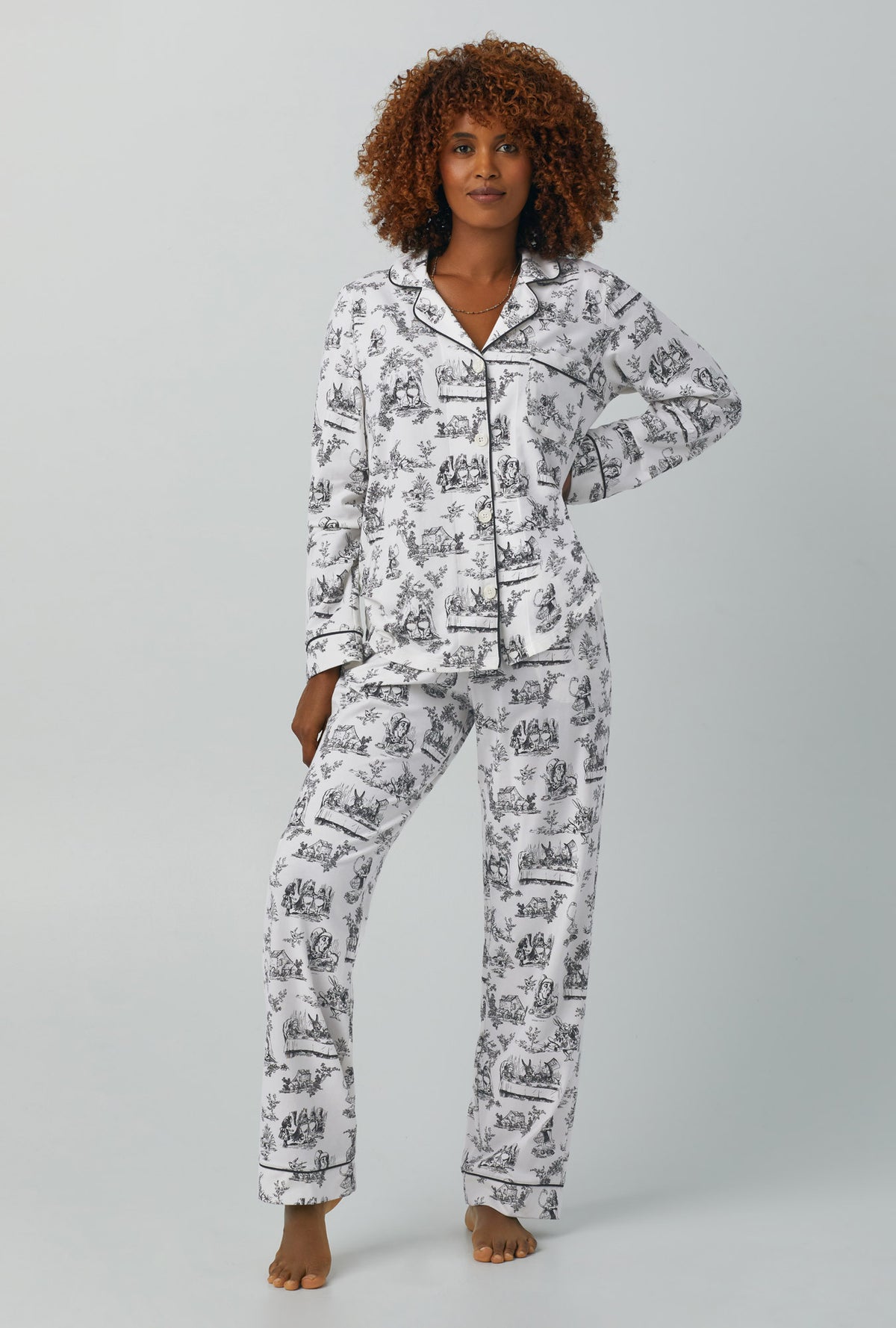 A lady wearing white Long Sleeve Classic Stretch Jersey PJ Set with Adventures in Wonderland print