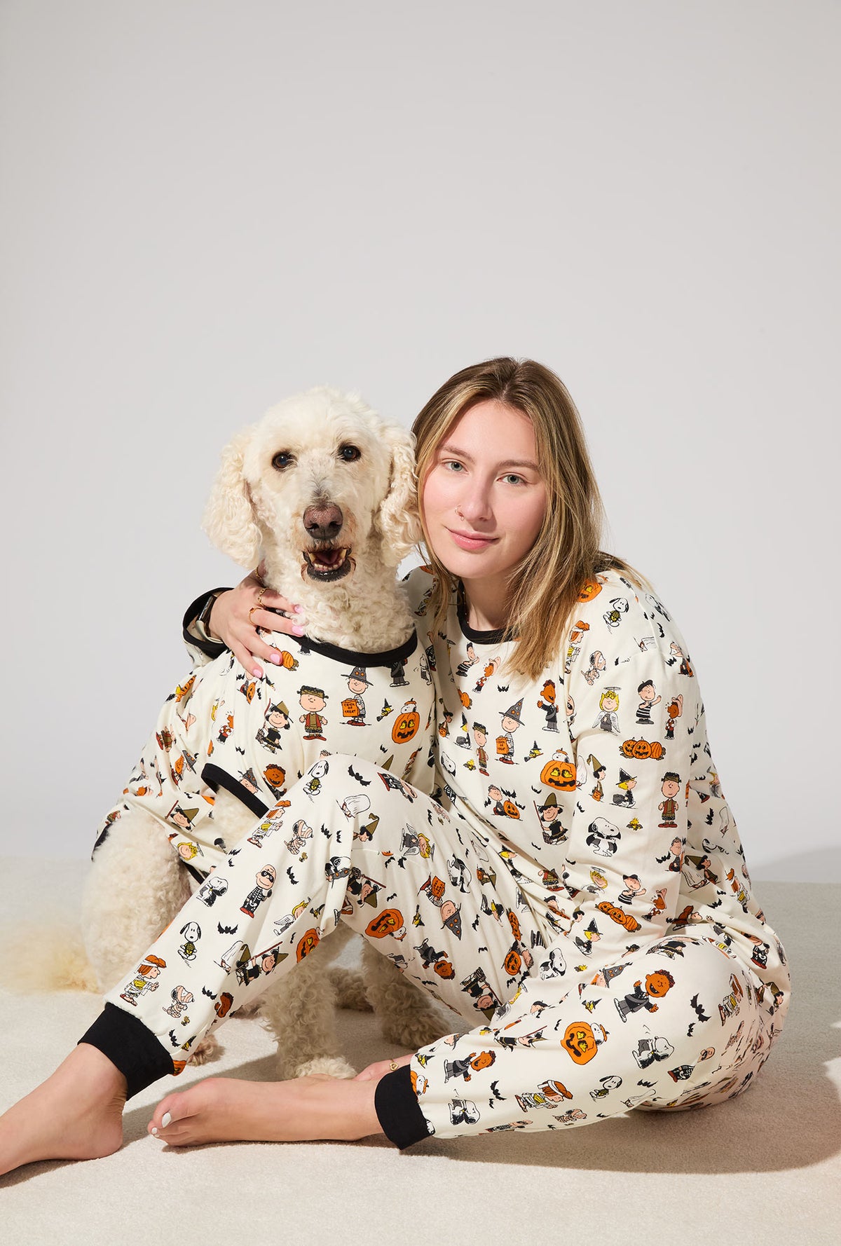 A dog wearing Peanuts® Snoopy&#39;s Halloween Stretch Jersey Dog Pajama