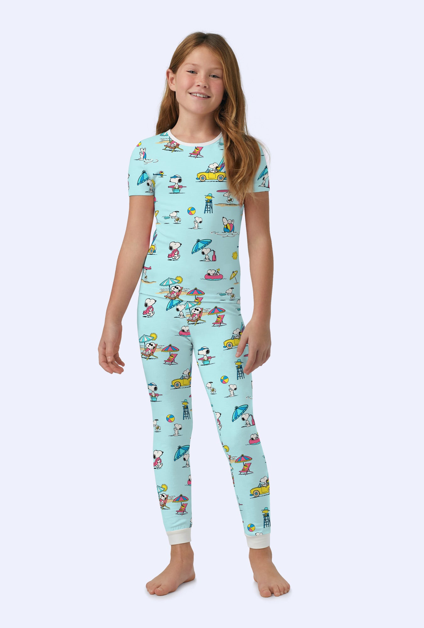 A girl wearing Surfside Snoopy® Short Sleeve Stretch Jersey Kids PJ Set