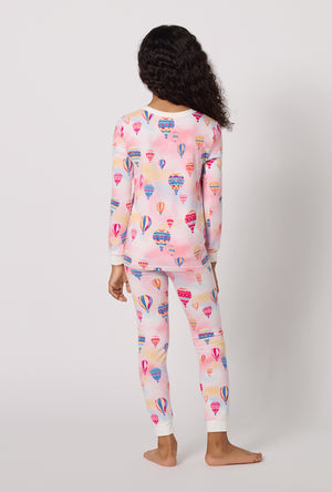 A Girl Wearing Serene Sunrise Long Sleeve Stretch Jersey Kids Pj Set in a back view pose