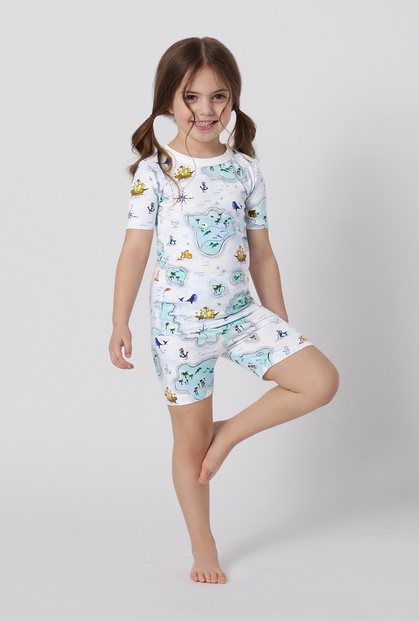 A little girl wearing Treasure Hunt Short Sleeve Stretch Jersey Kids Short Pj Set