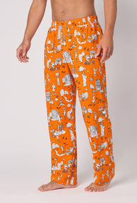 A Man Wearing Orange Spooky In The City Men's Stretch Jersey Pj Pant in a side angled pose