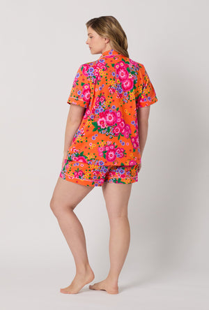 A lady wearing plus size Orange Short Sleeve Classic Shorty Stretch Jersey Pj Set back view