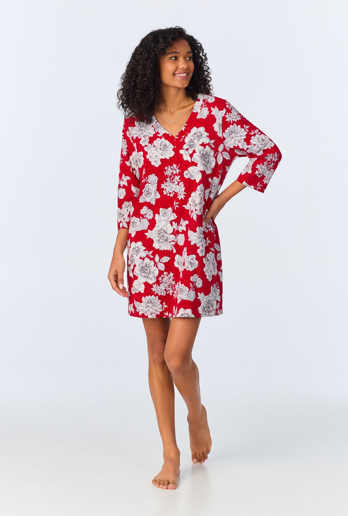 A lady wearing red quarter sleeve  stretch jersey sleepshirt with camellias print.