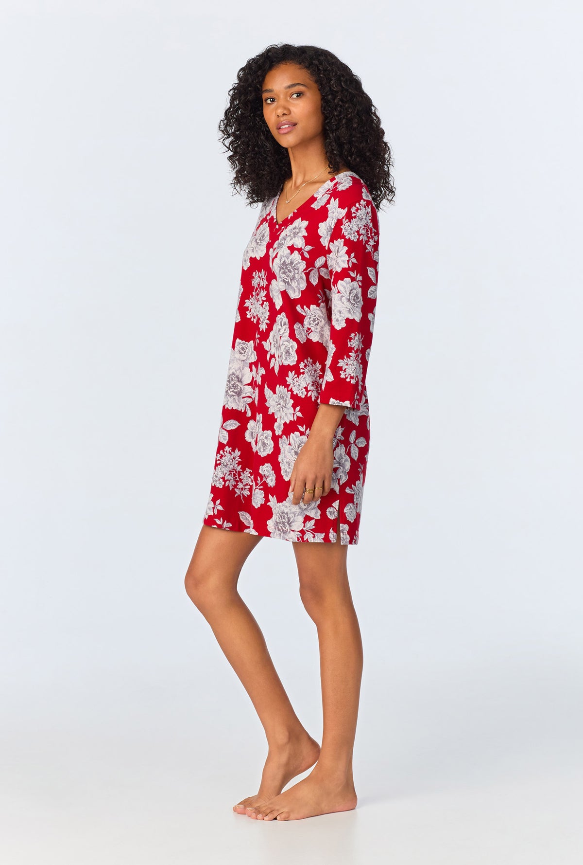 A lady wearing red quarter sleeve  stretch jersey sleepshirt with camellias print.