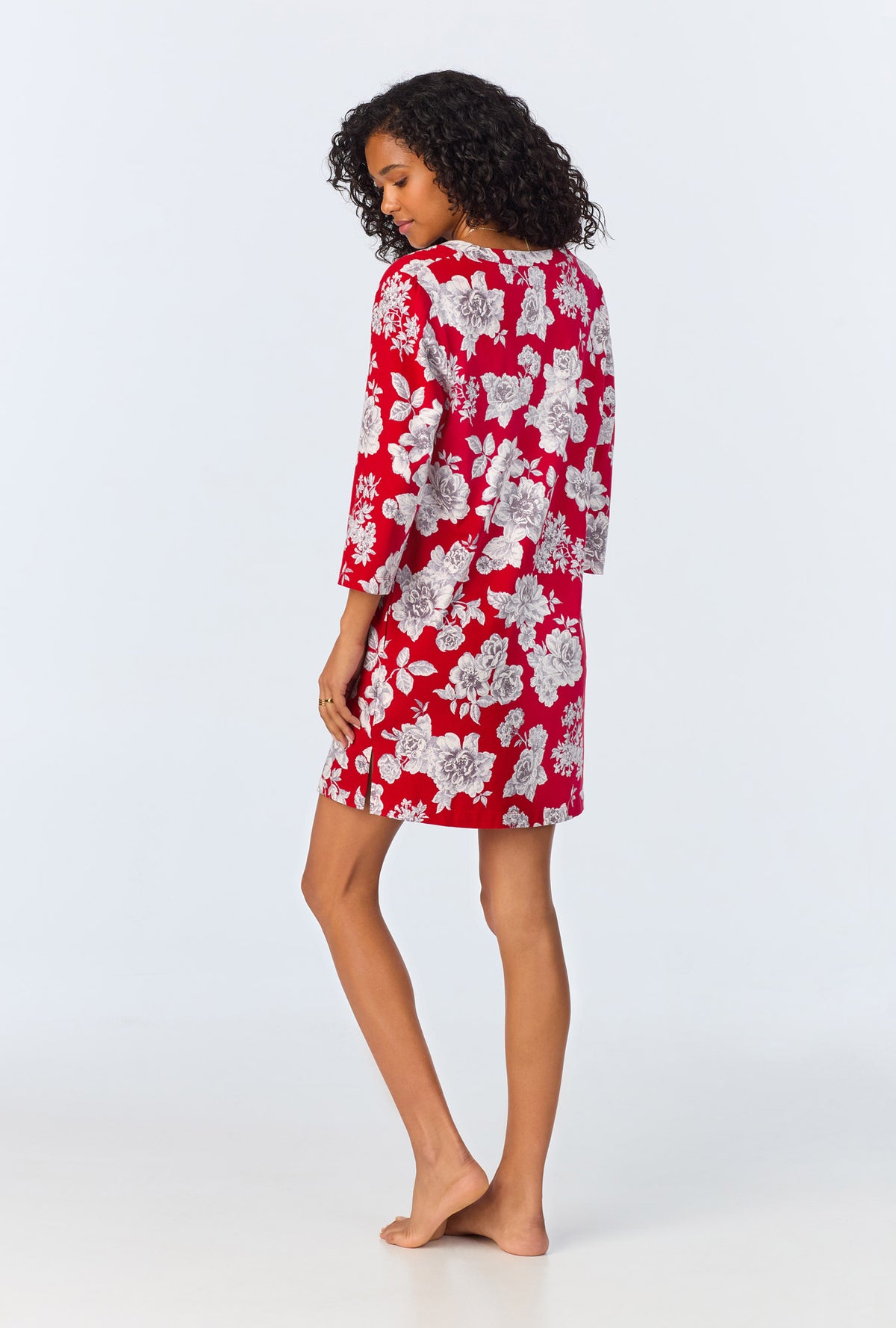 A lady wearing red quarter sleeve  stretch jersey sleepshirt with camellias print.