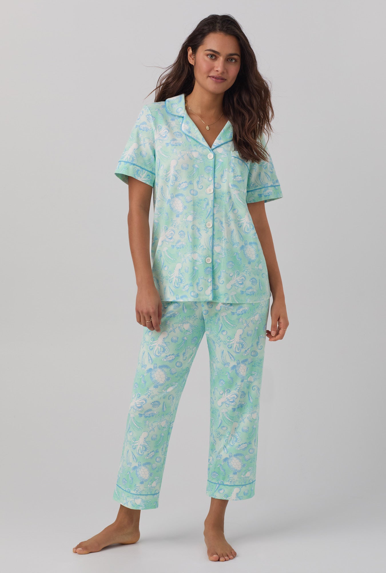 A lady wearing short sleeve stretch jersey cropped pj set with aquatic life print