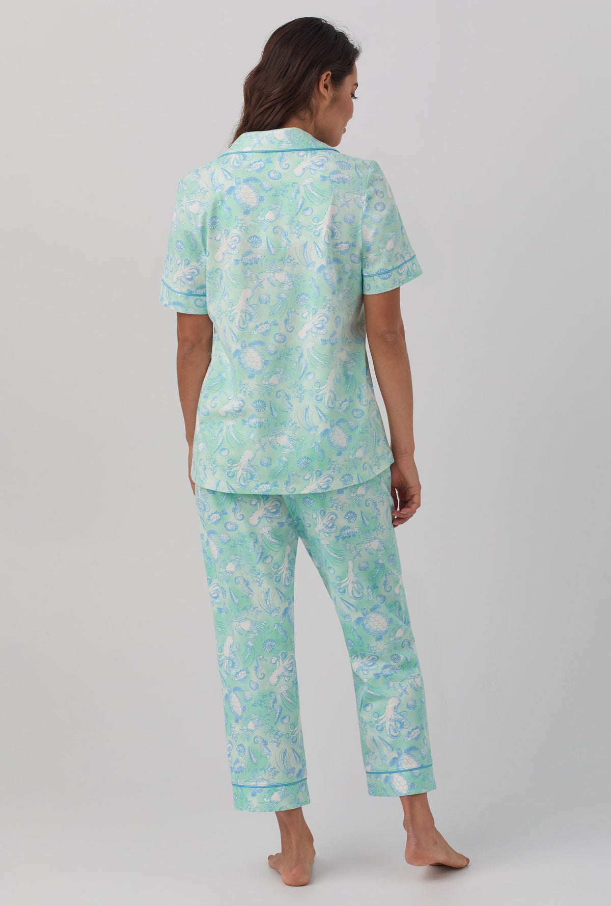 A lady wearing short sleeve stretch jersey cropped pj set with aquatic life print