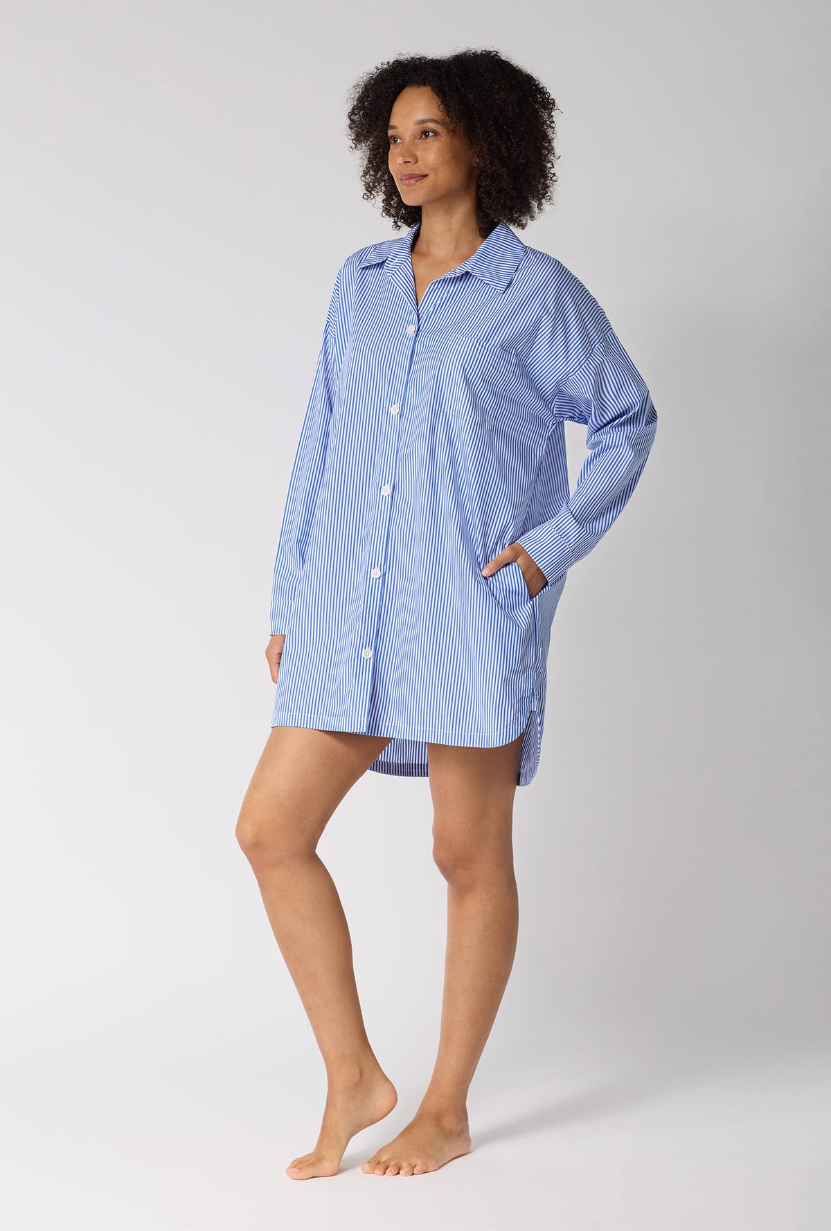 A Lady Wearing French Stripe High Low Woven Supersoft Cotton Poplin Boyfriend Shirt in a side angled pose