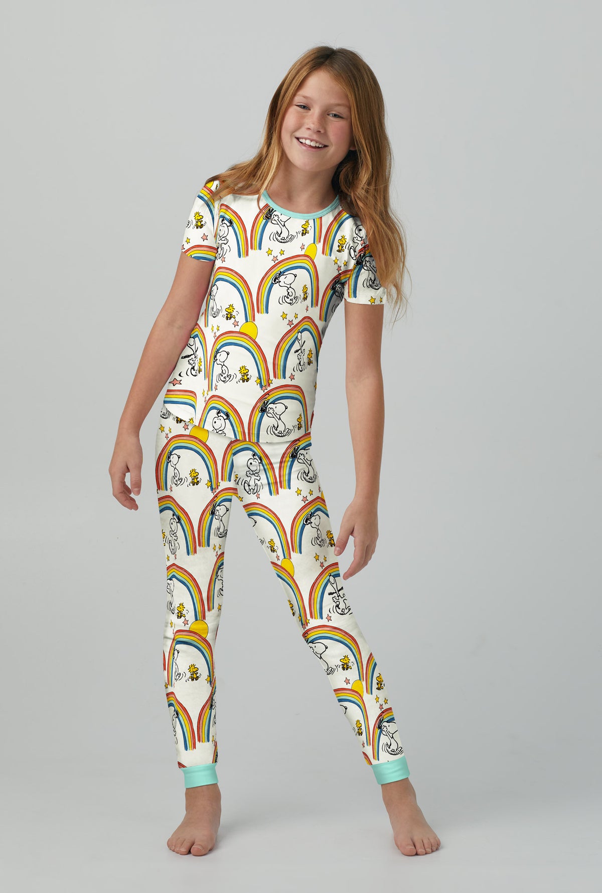A girl wearing white Snoopy Long Sleeve Stretch Jersey Kids PJ Set with Sunshine print.
