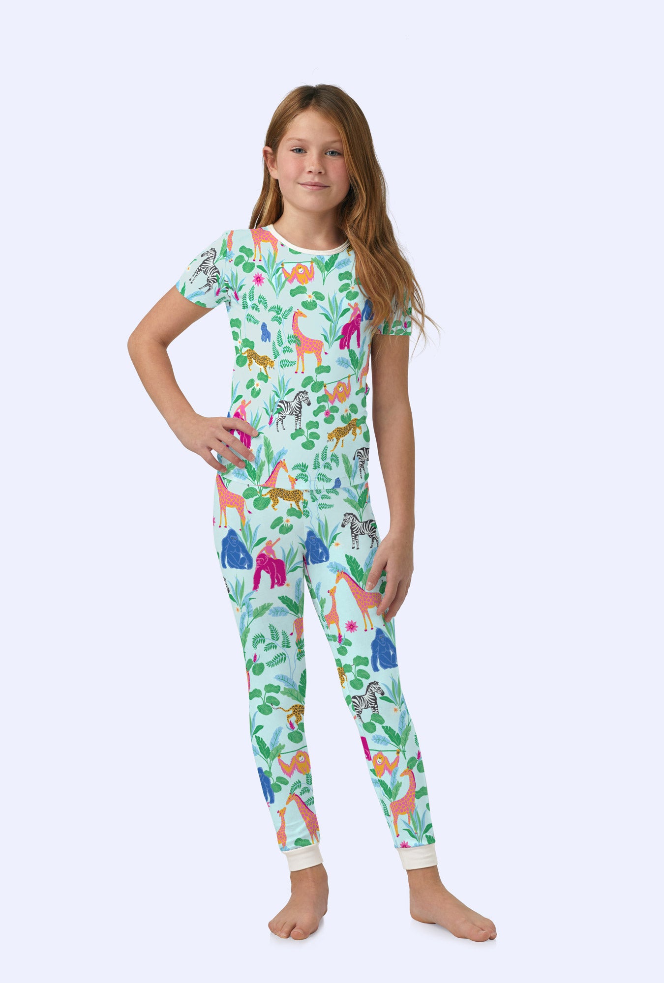 A girl wearing short sleeve stretch jersey pj set with addos birthday bash print