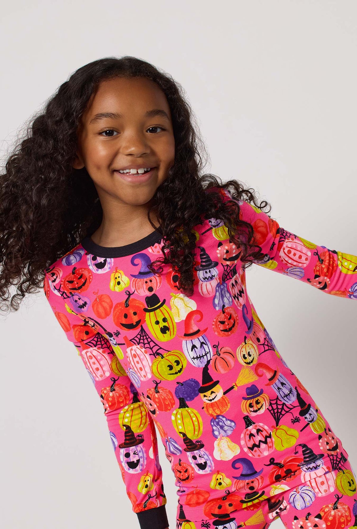 A Girl Wearing Pumpkin Patch Party Long Sleeve Stretch Jersey Kids Pj Set in a close up view pose