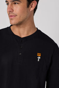 A Man Wearing Spooky Season Snoopy Men's Long Sleeve Henley And Jogger Stretch Jersey Pj Set in a close up view pose