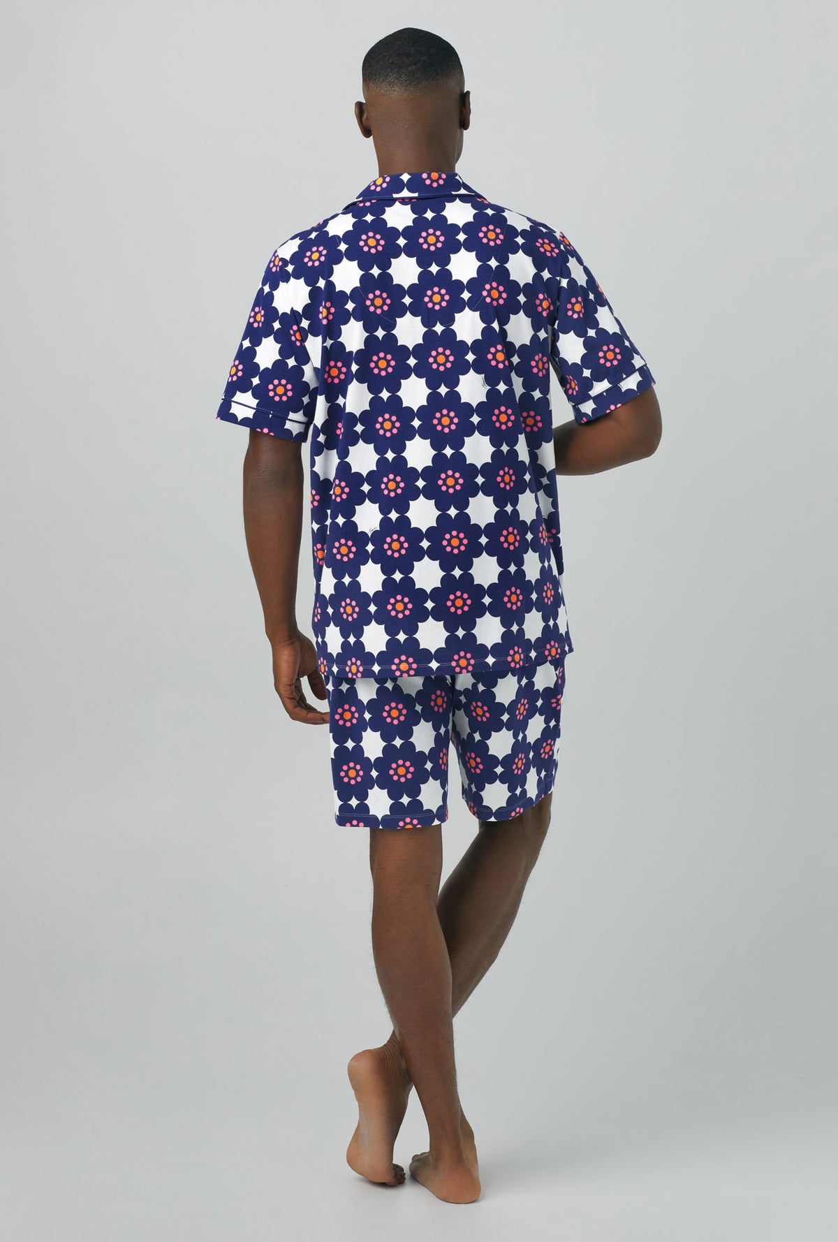 A man wearing Short Sleeve Notch Stretch Jersey Short PJ Set with floral tile print