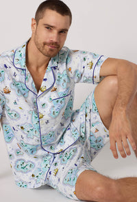 A man wearing Treasure Hunt Men's Short Sleeve Classic Stretch Jersey Short Pj Set closer look sitting on the floor