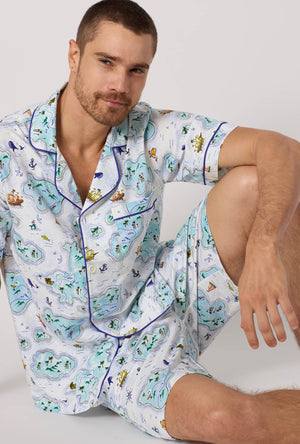 A man wearing Treasure Hunt Men's Short Sleeve Classic Stretch Jersey Short Pj Set closer look sitting on the floor