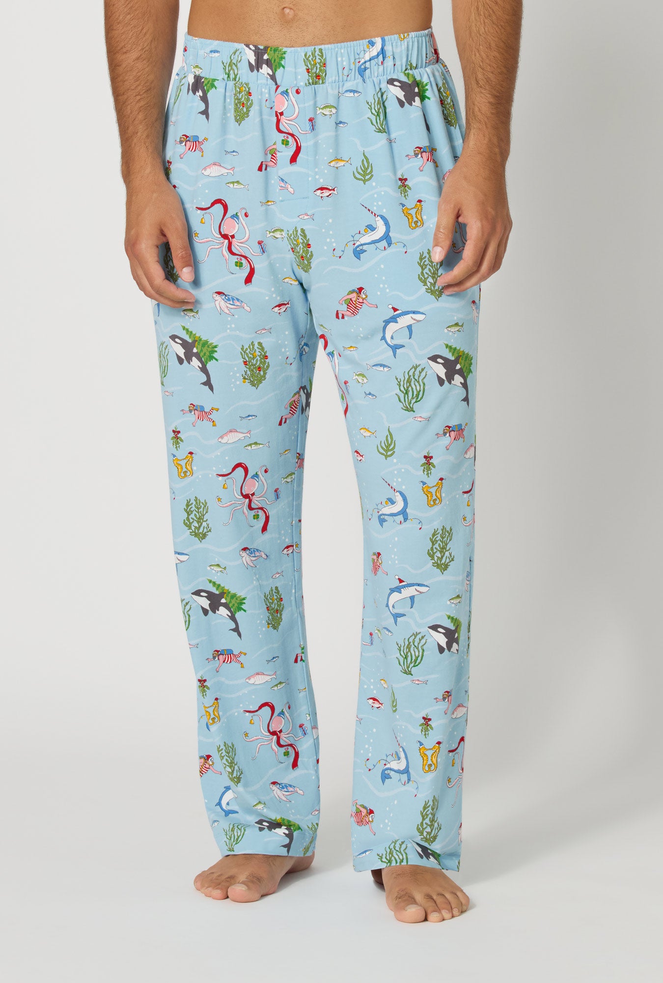 A man wearing Jingle All The Wave Men's Stretch Jersey Pj Pant