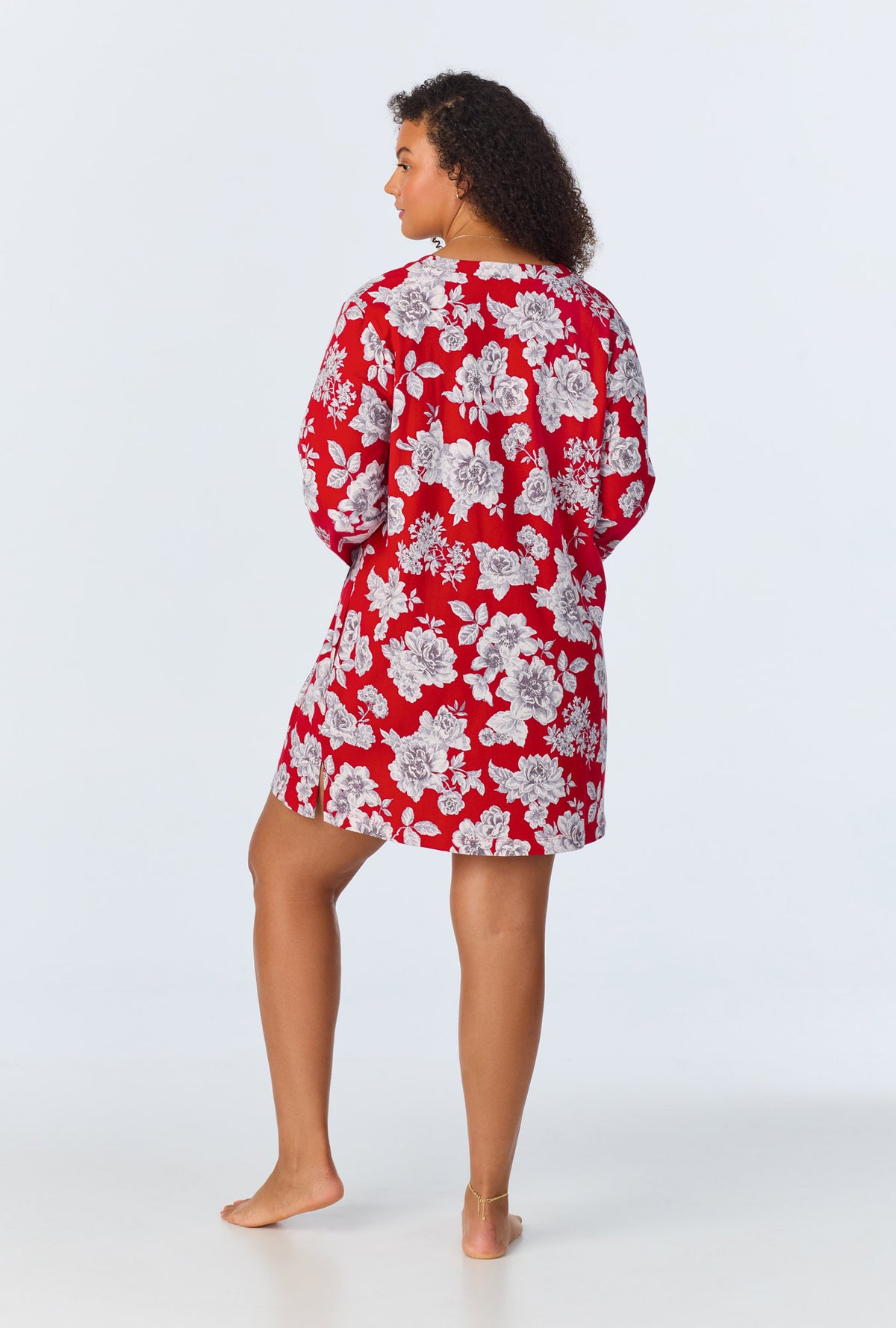 A lady wearing red quarter sleeve  stretch jersey plus size sleepshirt with camellias print.