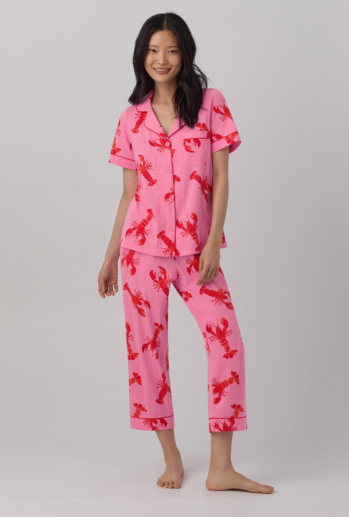 A lady wearing  pink  Short Sleeve Classic Stretch Jersey Cropped PJ Set with Lobster Fest print.