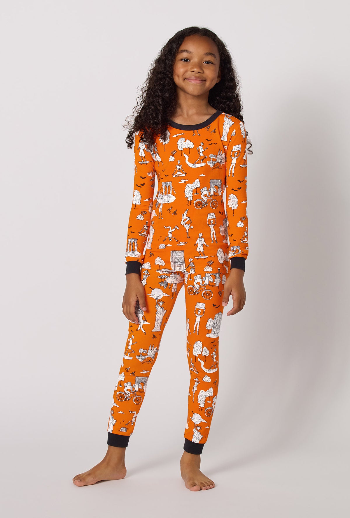 A Girl Wearing Orange Spooky In The City Long Sleeve Stretch Jersey Kids Pj Set