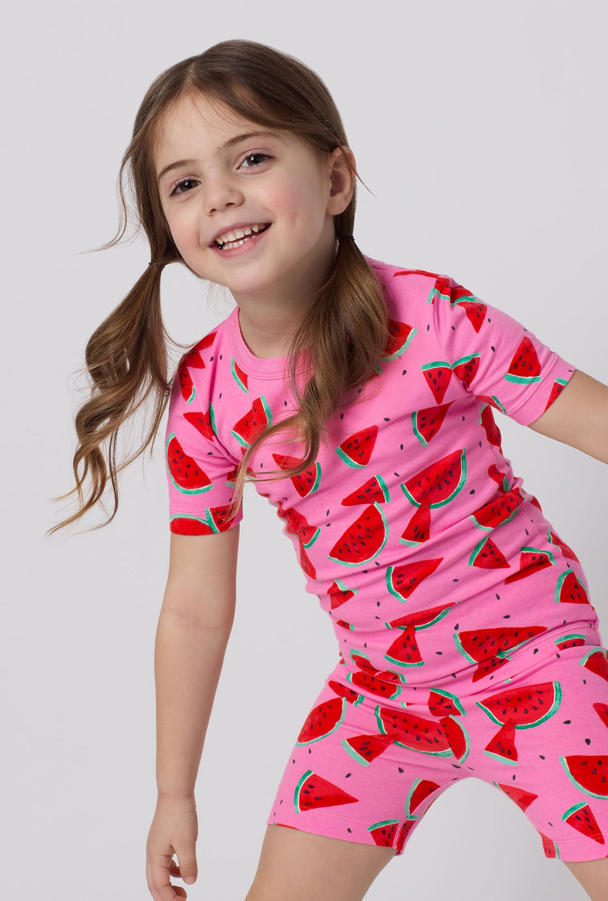 A little girl wearing Watermelon Crush Short Sleeve Stretch Jersey Kids Short Pj Set closer look