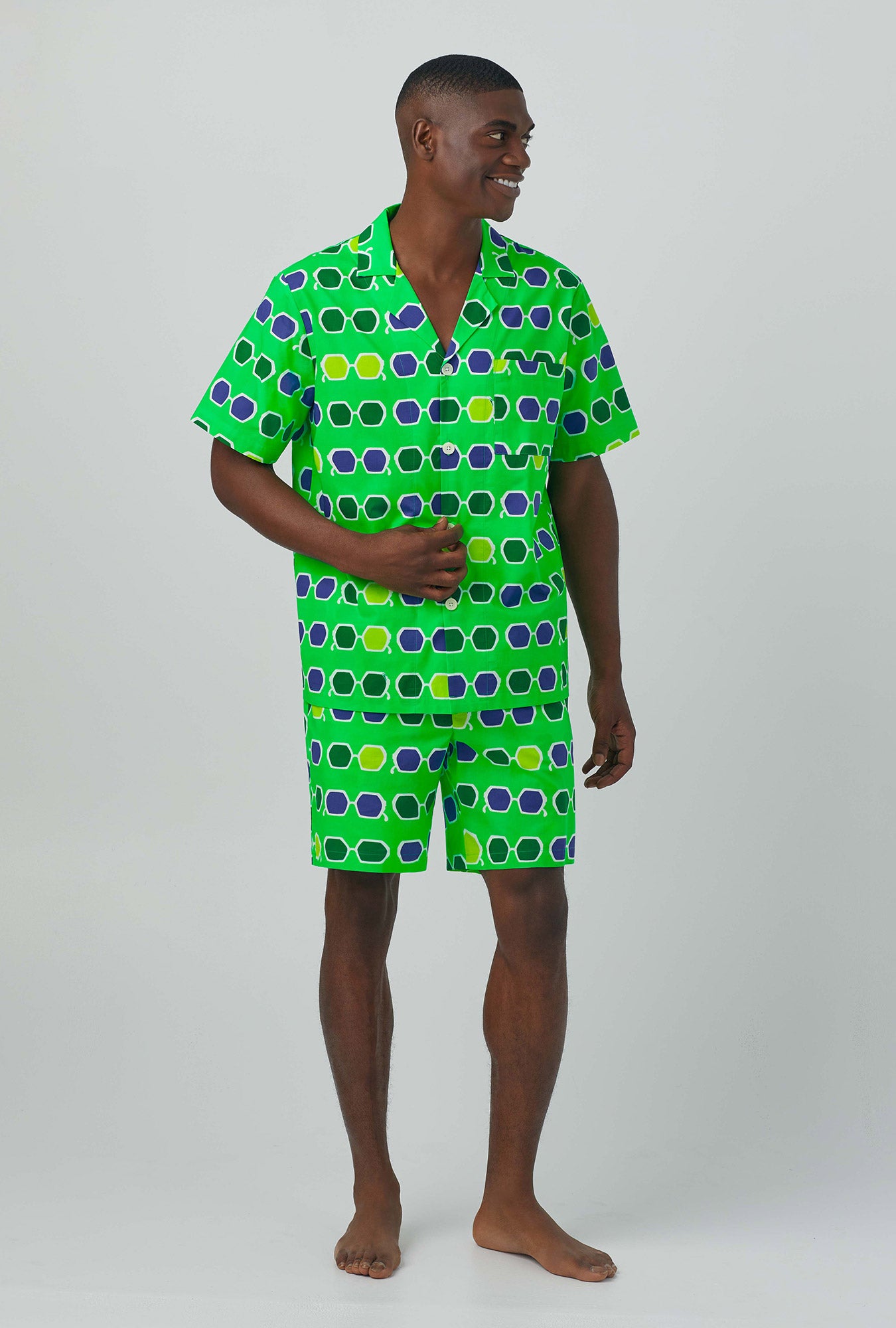 A man wearing green Short Sleeve Notch Woven Cotton Poplin Boxer PJ Set with sunglasses print
