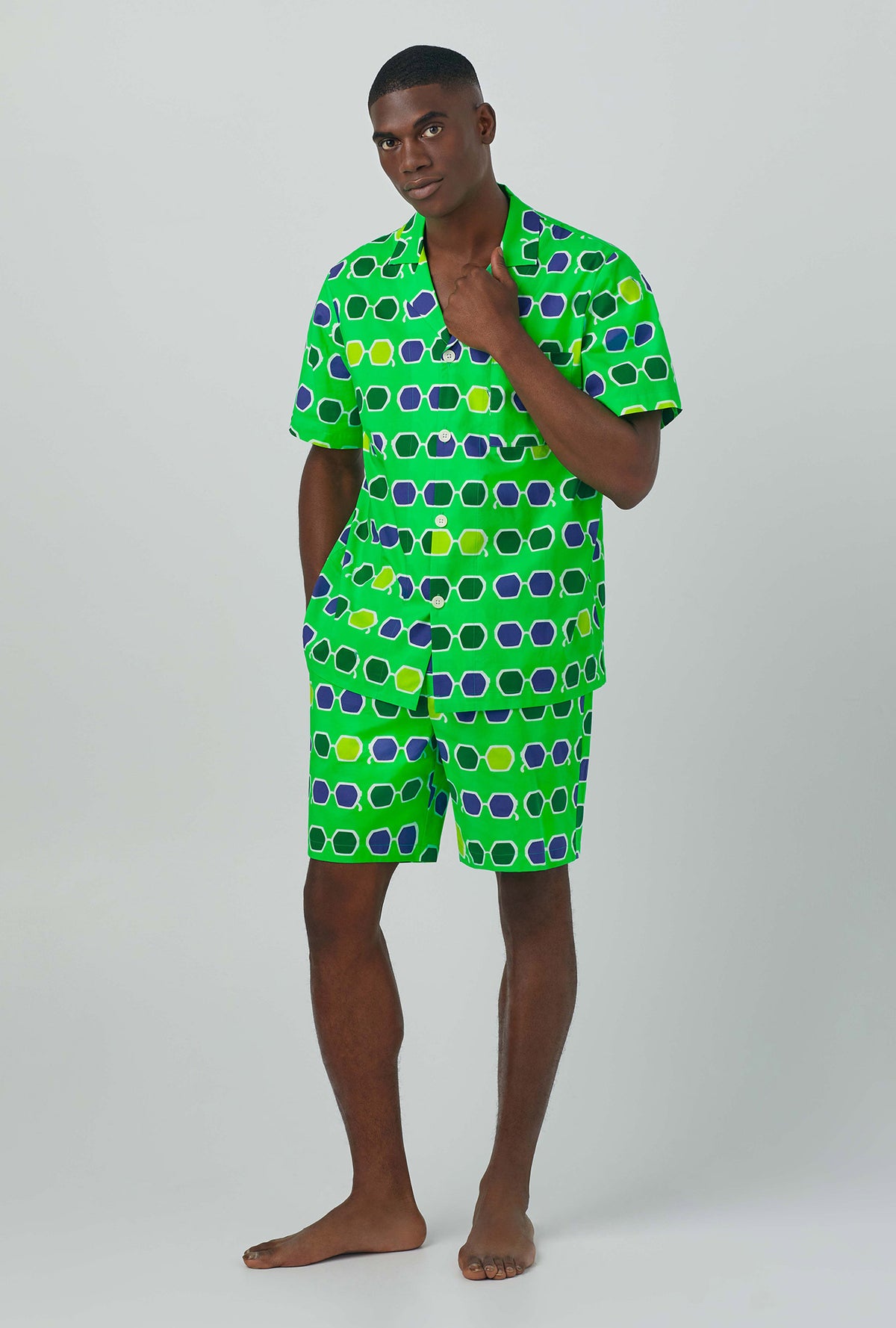 A man wearing green Short Sleeve Notch Woven Cotton Poplin Boxer PJ Set with sunglasses print